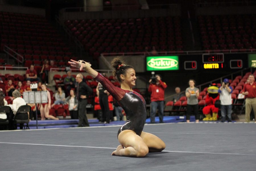 Hilary Green smiles as she finishes her floor routine on Feb. 17 in Hilton Coliseum. Green tied for third place on floor. The Cyclones won their tri-meet against Illinois State and Gustavus with a score of 195.625.