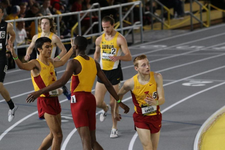 Iowa State distance runners Dan Curts (right), Roshon Roomes (left) and Zach Black celebrate after sweeping the top three spots at the Hawkeye Invite on Jan. 14. 