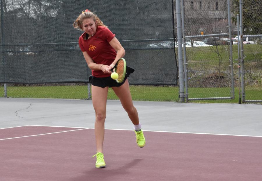 Iowa State junior Samantha Budai hits a tennis ball in her singles match against Kansas on April 10. The tennis match was suspended for a short period due to rain. The Cyclones lost 4-2.