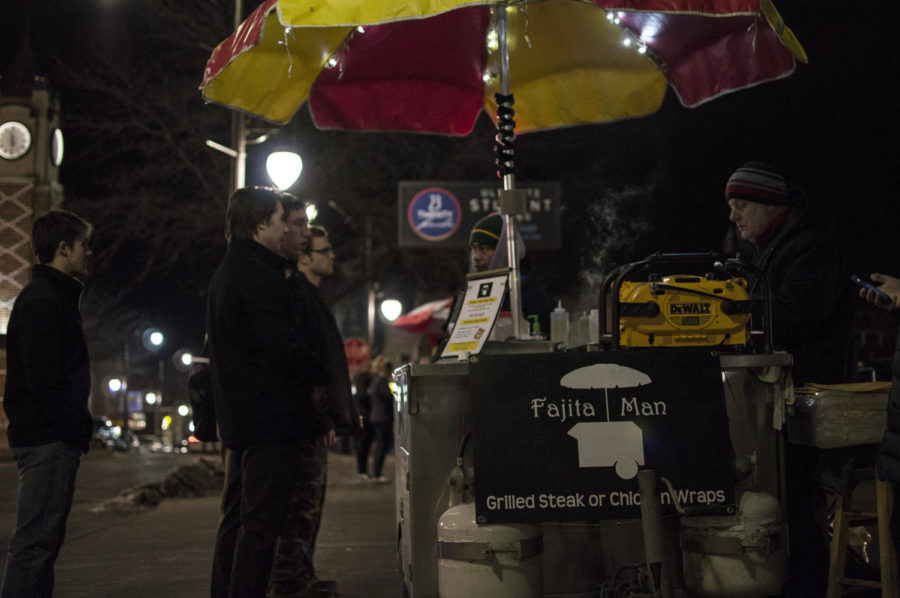 As Mark Motsch is setting up the Fajita Man cart, people already begin to form a line. Motsch attracts a crowd of customers late at night on Welch Avenue.