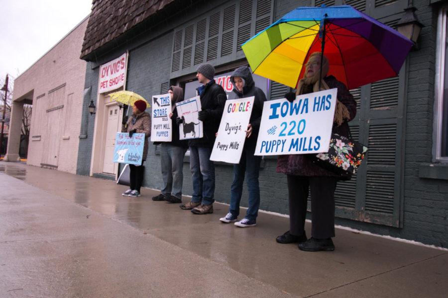 Organized protesters from the group Bailing Out Benji stand outside Dyvigs Pet Shoppe in Ames.
