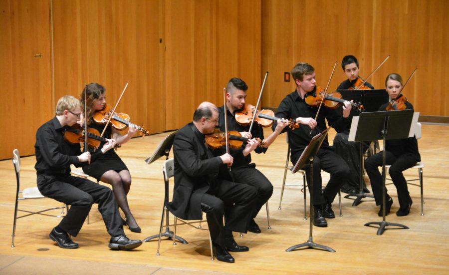 The violin section of the ISU Chamber Orchestra performs with Borivoj Martinic-Jercic, assistant professor of music, during their performance at the Martha-Ellen Tye Recital Hall on Mar. 27.