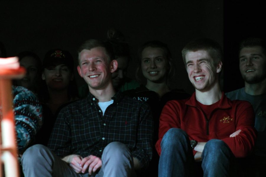 Audience members laugh during comedian Jordan Carlos' performance in the Maintenance Shop on March 1.