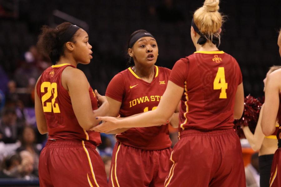 Iowa State senior Seanna Johnson encourages teammates Heather Bowe and TeeTee Starks during a time out against Kansas State in the Big 12 tournament.
