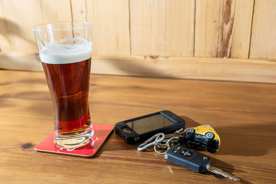 Car keys with a pint of beer and a mobile phone
