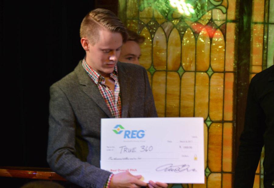 Chris James, freshman in pre-business, accepts his $1,000 check for winning overall best pitch at the Innovation Pitch event held in the M-Shop March 8. 