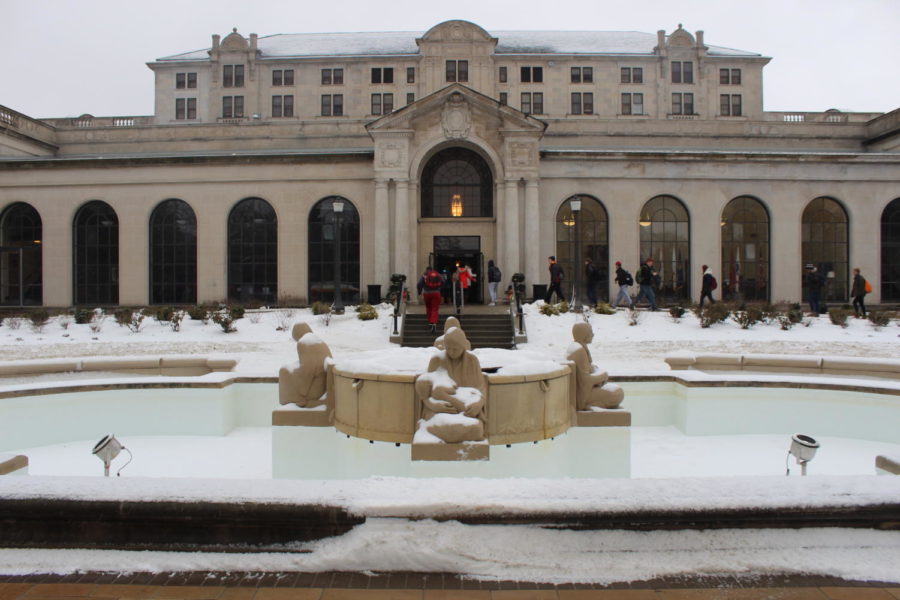 Students walk passed the snow-covered Fountain of the Four Seasons into the Memorial Union on Jan 25. The campus was covered with 1-3 inches of snow overnight, which continued through the morning. 