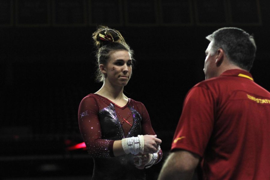 Meaghan Sievers talks to Coach Ronayne after she fell during her bar routine. The Cyclones won their tri-meet on Feb. 17 against Illinois State and Gustavus with a score of 195.625.