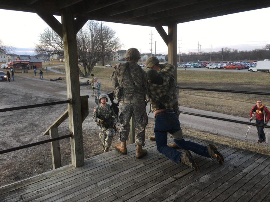 Cadets pull a casualty from the building during a training exercise. 