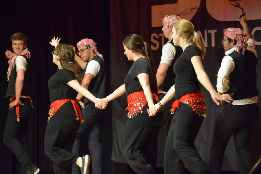 Arab Student Association members dance an Arabian dance that represents the countries of Palestine, Lebanon, and Syria during Global Gala March 31. This dance originated as a way of stomping on rooftops to create even roofs for houses.