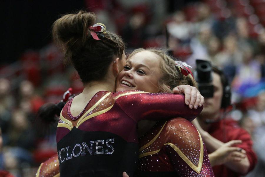 Sophomore Haylee Young (right) hugs freshman Meaghan Sievers after her floor exercise routine during the meet against Iowa at Hilton Coliseum March 4. Young scored a 9.925, contributing to the Cyclones narrow 196.025-196.0 victory over the Hawkeyes. 