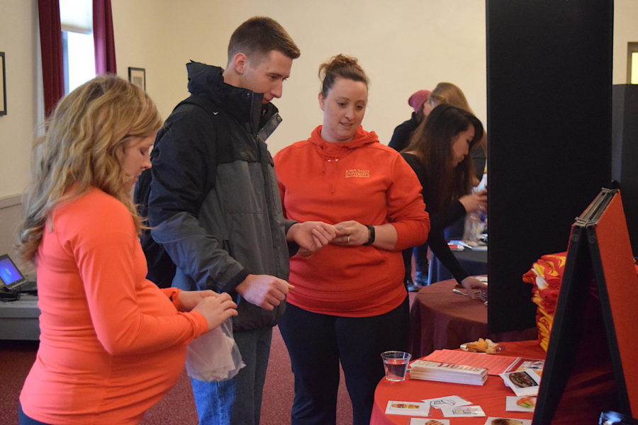 Vendors with self-care products and services talk to students like Aaron Zoellner, junior in psychology, at the Rock Your Body event to raise awareness for body image issues and eating disorders. Rock Your Body took place in the Cardinal Room, March 2 and is apart of BEIDA week.
