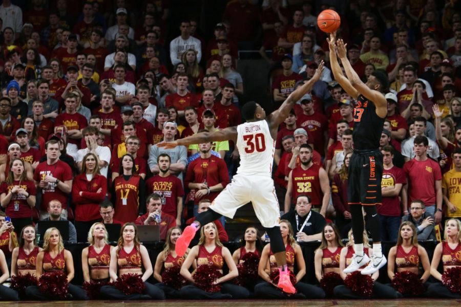 Deonte Burton puts a hand up while Oklahoma States Leyton Hammonds puts up a shot on Tuesday. Iowa State beat the Cowboys 86-83.