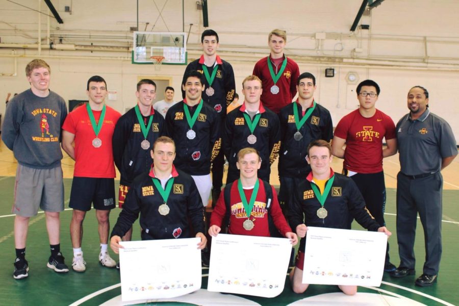 Members of the Iowa State Wrestling Club pose for a picture after winning the Great Plains Conference Tournament.