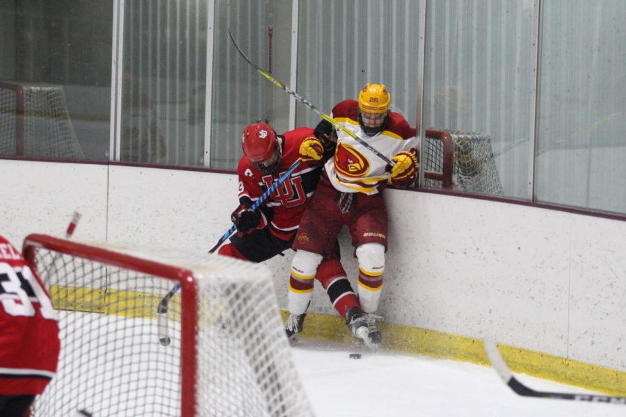 Senior Dalton Kaake gains control of the puck behind the University of Utahs goal on Feb. 10. They Cyclones lead 5-2 at the end of the second period.
