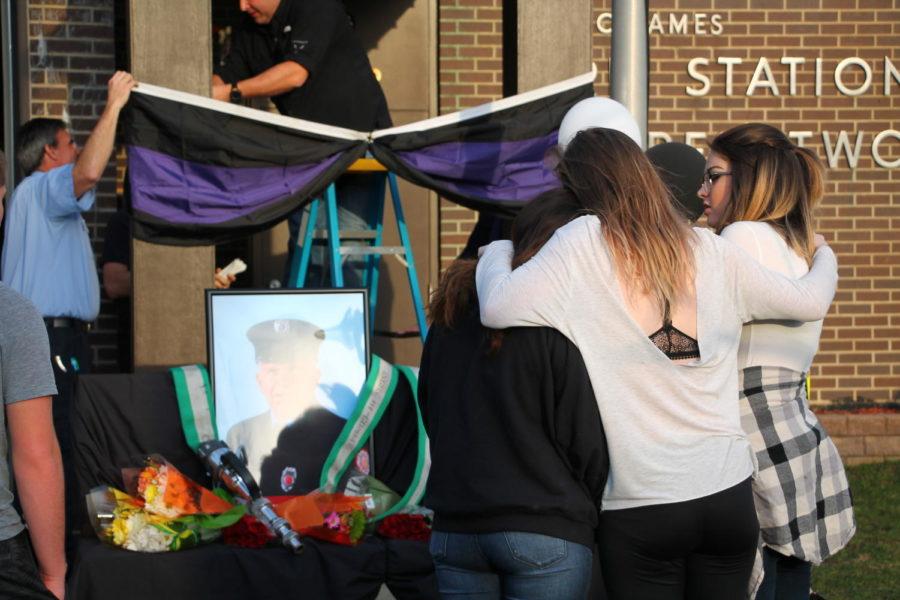 Three young women mourn the loss of Ames firefighter Steve Buser outside Fire Station No. 2 on Welch Ave March 19. Buser died early Friday after being found unresponsive at the station. 