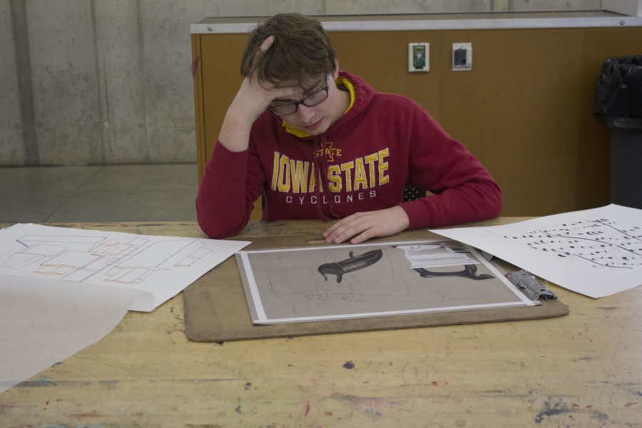 Jacob Gasper, sophomore in pre-architecture, looks at some of the projects he has worked on. Design students put hours of work into their projects.