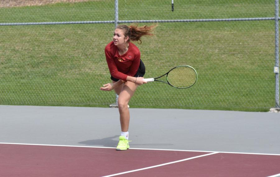Iowa State junior Samantha Budai leans for shot at the Kansas tennis match at the Forker Tennis Courts on April 10. Kansas won all of the singles matches. ISU fell 4-2.