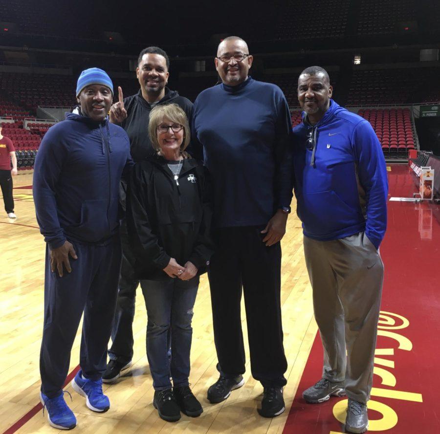 Julie Voss, administrative specialist for the men's basketball team, with former players (left to right) Paul Beene, Lafester Rhodes, Sam Hill and Carlton Evans.