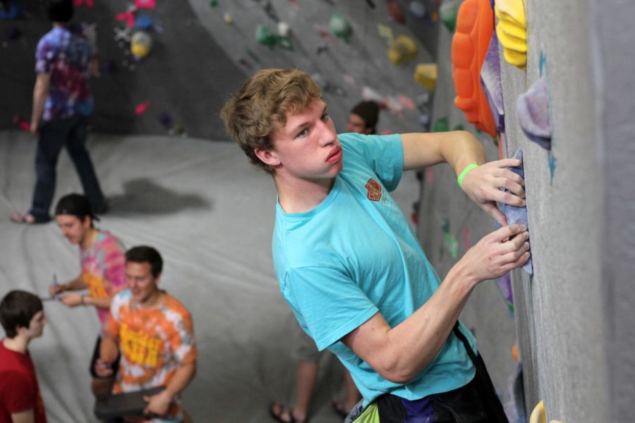 Lucas Fleissner prepares to grab his final handhold during Boulder Bash on April 8 at Lied Recreation Center.