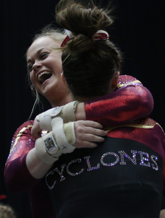 Sophomore Haylee Young celebrates the Cyclones narrow 196.025-196.0 victory over the Hawkeyes with freshman Meaghan Sievers March 4. 