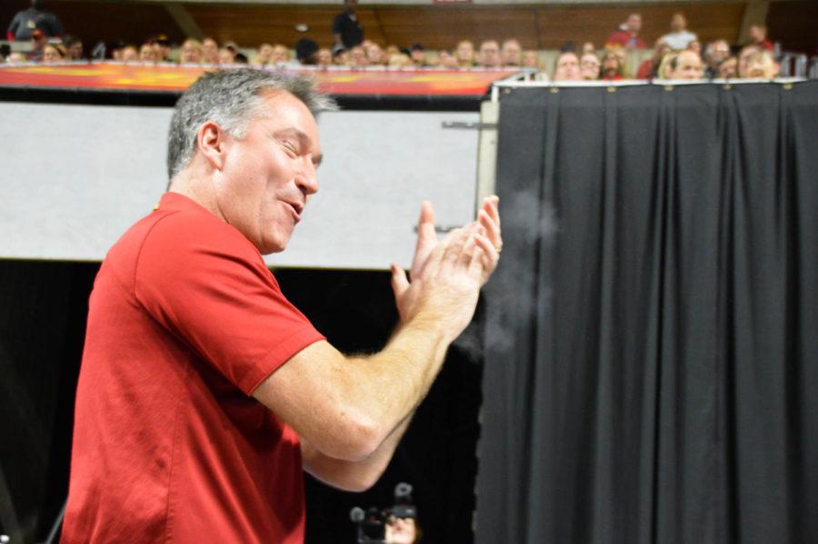 Iowa State Gymnastics Head Coach Jay Ronayne cheers on sophomore Meaghan Sievers as she finishes her uneven bars routine during The Beauty and The Beast event at Hilton Coliseum on Jan. 27. Sievers would go on to earn a score of 9.850. 