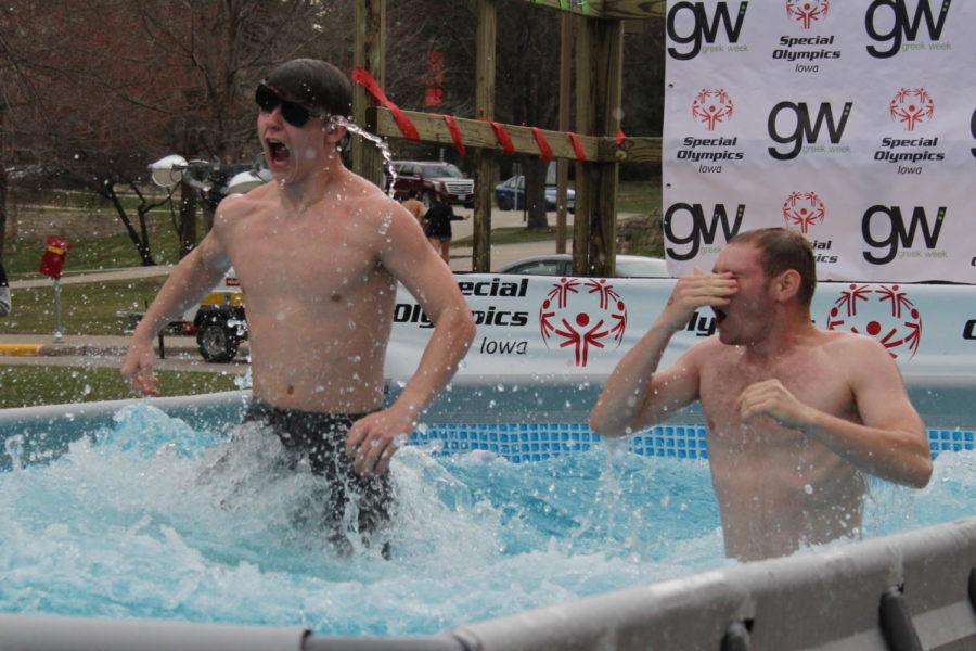 Two fraternity brothers jump into the freezing cold water during the Polar Plunge to benefit the Special Olympics outside of the Memorial Union on April 1. The Greek community together raised nearly $356,000 by the time the plunge started. 