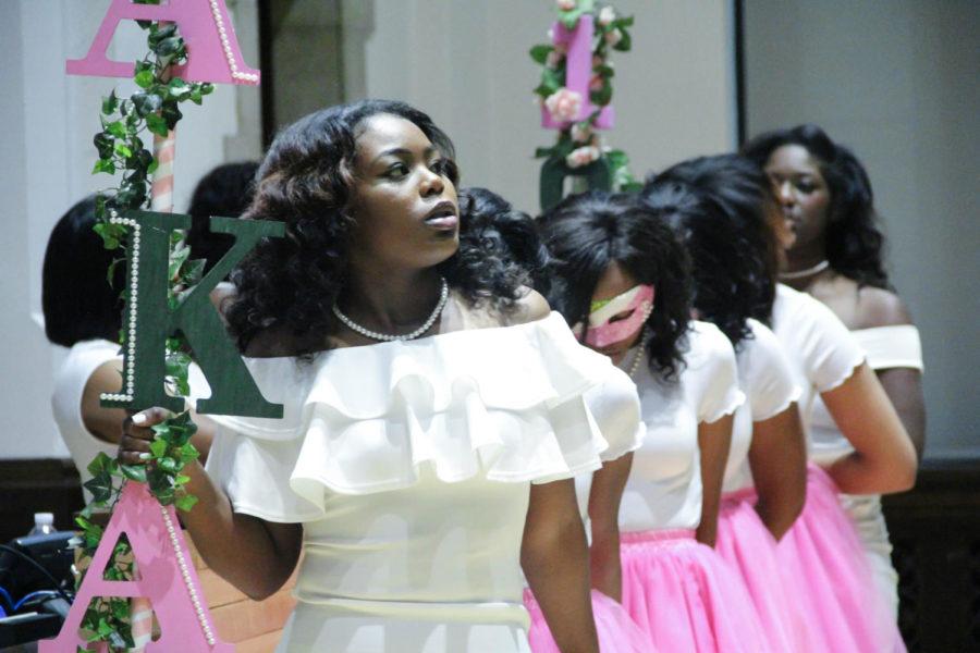 An Alpha Kappa Alpha member leads four new members to the center of the room to start the Neophyte Presentation April 24.