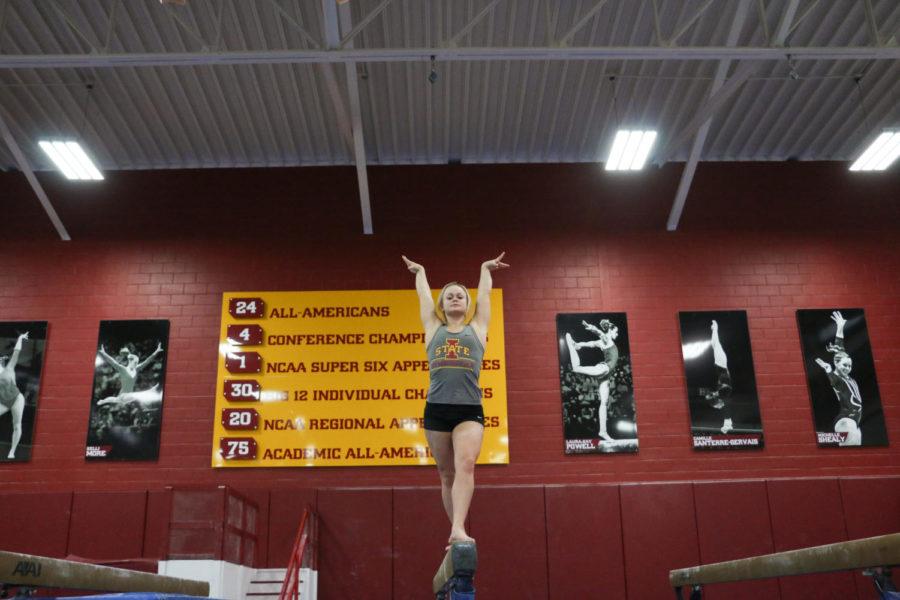 Before each practice, Haylee Young, a junior, glances at photos of eight of her predecessors as motivation. Young hopes to be the next All-American gymnast in the Iowa State gymnastics program history. 