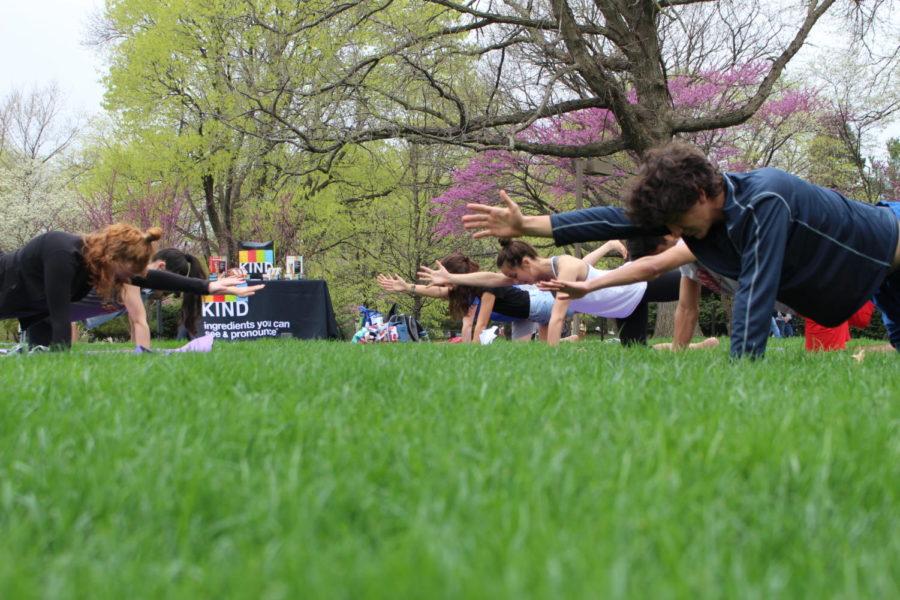Students do yoga by the Campanile for Earth Week on April 18.