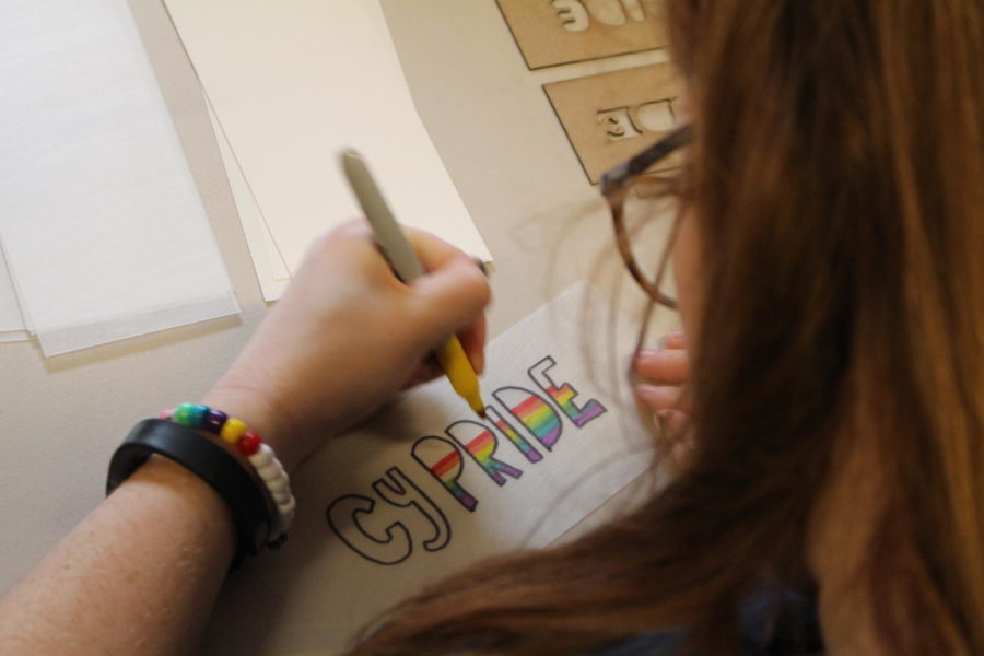 A student decorates a keychain during the Pride Week Swag Making event at the LGBT Services Center April 14.