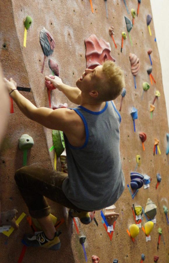 Tyler Gardner, Senior at the University of Northern Iowa, attempts to dino, or jump, to a difficult hold during the Bouldering Bash on March 9, 2013 at Lied Recreation.