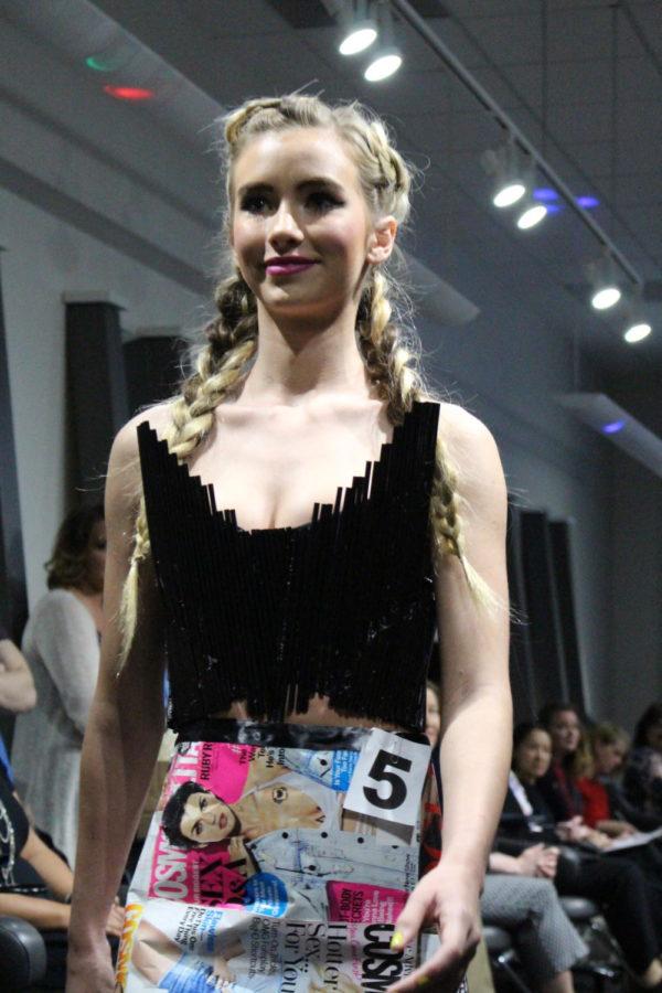 Serenity Couture hosted a Trashion Show where Iowa State fashion students made pieces out of garbage that could harm the environment. This model is wearing magazines.