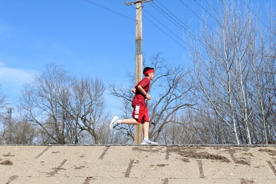 A runner jogs towards the finish line during the Doughnut Run, a 5k held in Brookside Park on April 8. 