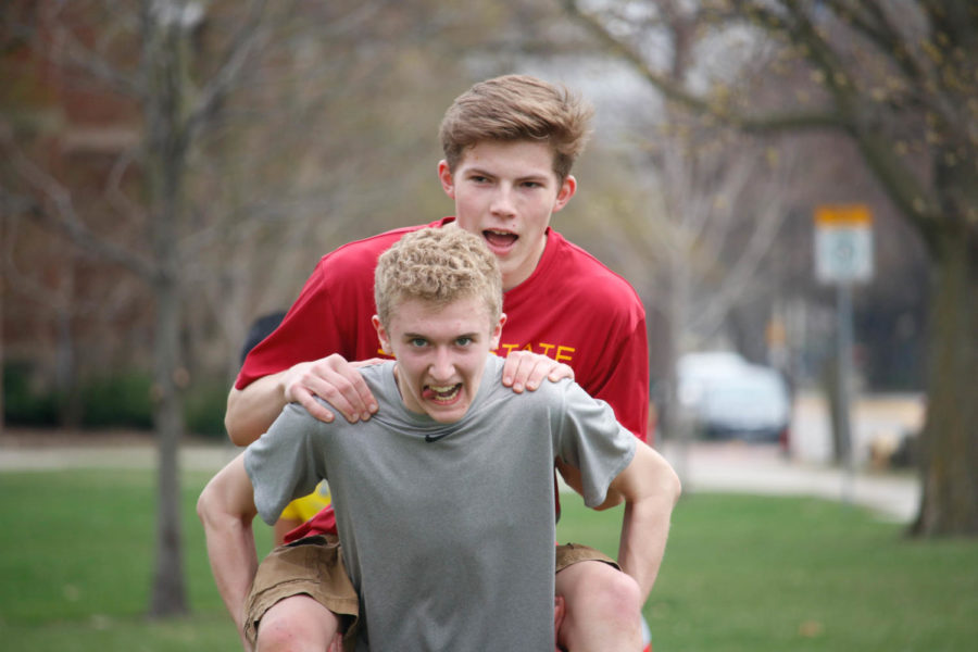 Two team members partake in the piggyback ride portion of Stop Five during the CyMazing Challenge. The third annual CyMazing Challenge started and concluded at the Alumni Center with ten other stops around campus on April 9.