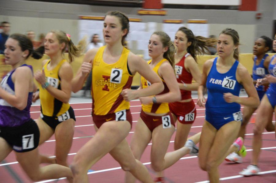 Sophomore Grace Gibbons and freshman Gwynne Wright run in the 3000 meter invite at the Iowa State Classic at Lied Recreation Center on Feb. 10. Gibbons finished with a personal record of 9:45.00 and Wright finished with a personal record of 9:43.96.