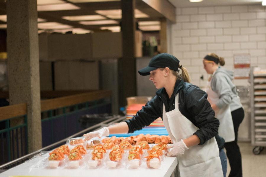A student assembles buffalo chicken wraps at the Knapp-Storms Commissary Kitchen Oct. 15. The buffalo chicken wraps, which are the most popular, take around an hour to assemble. 
