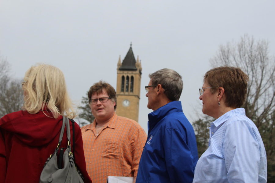 David Faux speaks to Ames community members during an art walk on April 12. Led by Faux, the art walk focused on how poetry affected the different works of art on campus, such as the statue of Carver and the Fountain of the Four Seasons. 