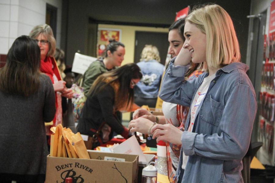 Senior Jaden Muller signs in volunteers during the Behind the Scenes event held for High school Students interested in Apparel merchandising and design April 7th. 