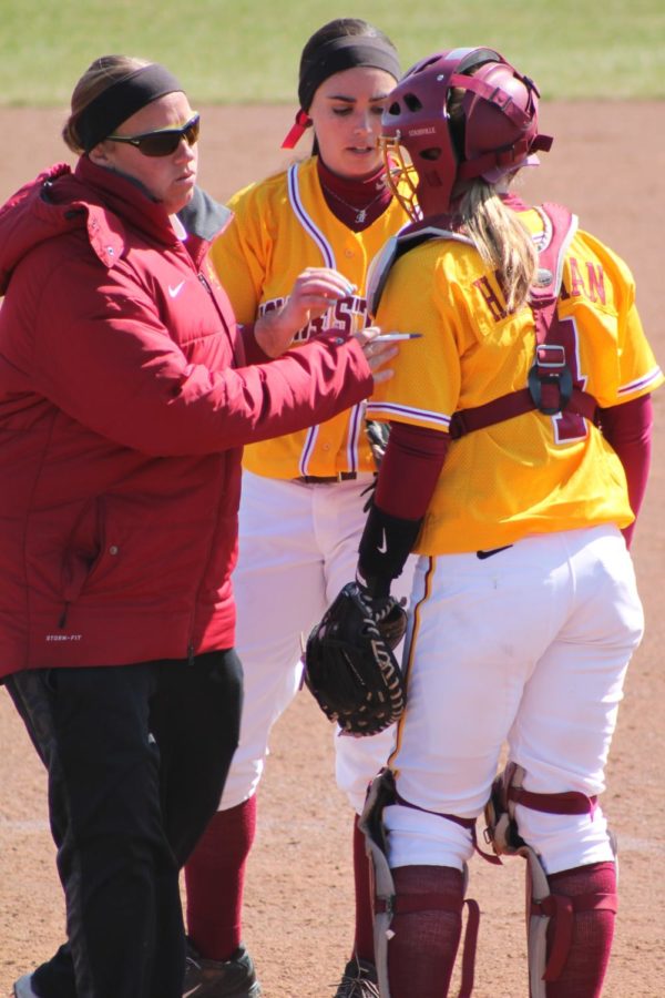 Coach Stacy Gemeinhardt-Cesler meets with Paris Imholz, junior, and Rachel Hartman, freshman, at the mound in the winding innings of the game against North Dakota. The Cyclones later won the series 2-0.