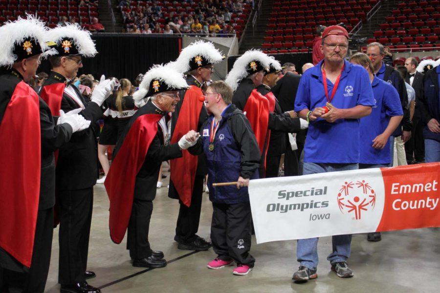 A Special Olympics participant shakes hands with a Knight of Columbus during the entrance parade during the Special Olympics Summer Games opening ceremony on May 25.