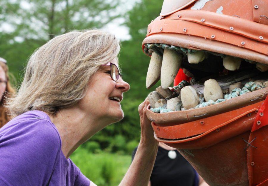 Kathy Wiederin stares into the mouth of Rufus the Triggerfish, one of the sculptures in the Washed Ashore exhibit in Reiman Gardens, on May 17. Reiman Gardens will be the first public gardens in the entire country to host this colorful, garbage-to-art exhibit.