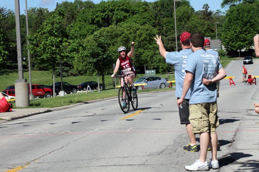 Jenny Dalton celebrates as she finishes a lap during a cycling event for Special Olympics of Iowa Summer Games on May 25.