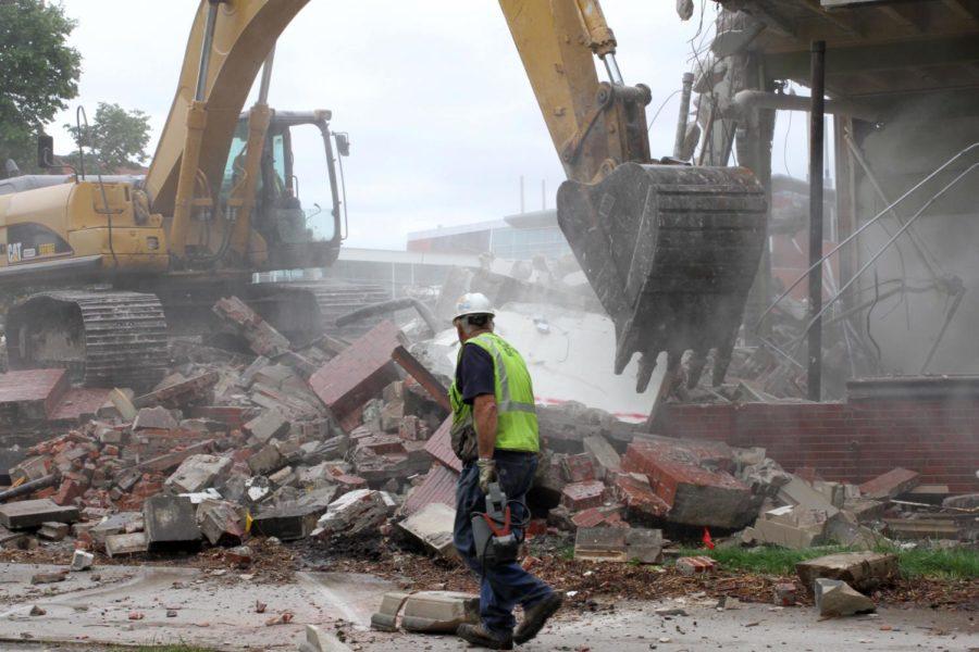 A construction worker walks near Sweeney Hall during demolition on May 18. The southeast section of Sweeney was removed to make room for the new Student Innovation Center, which is projected to be completed in 2020.