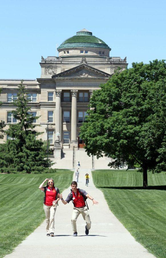 Two Cyclone Aides walk from Beardshear to Curtiss on the first day of new student orientation on May 31.