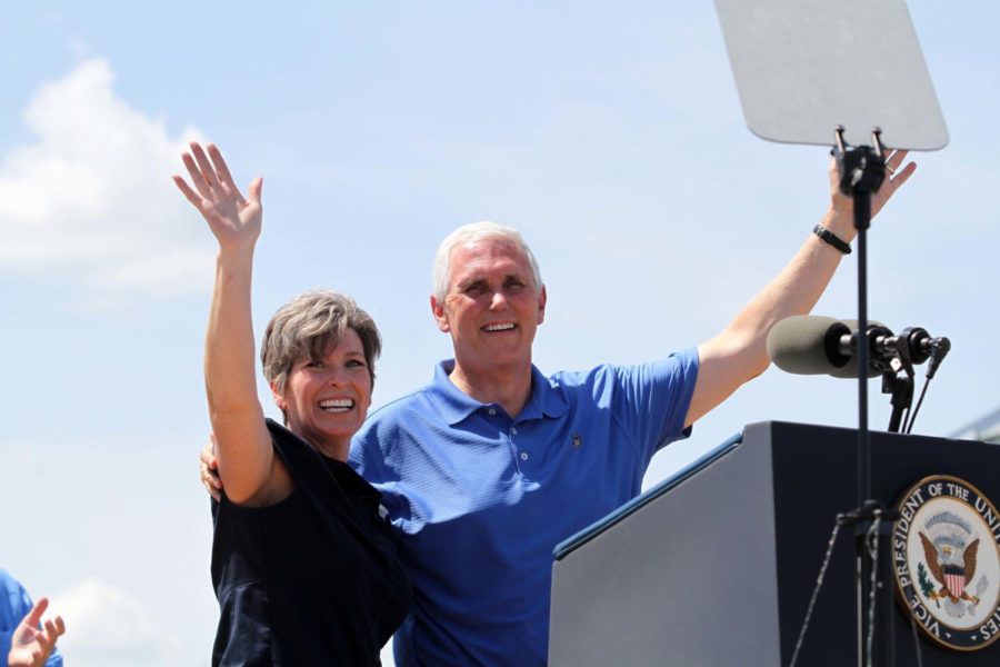 Senator Joni Ernst stands with Vice President Mike Pence after introducing him to speak at the Roast and Ride fundraiser on June 3 in Boone, Iowa.