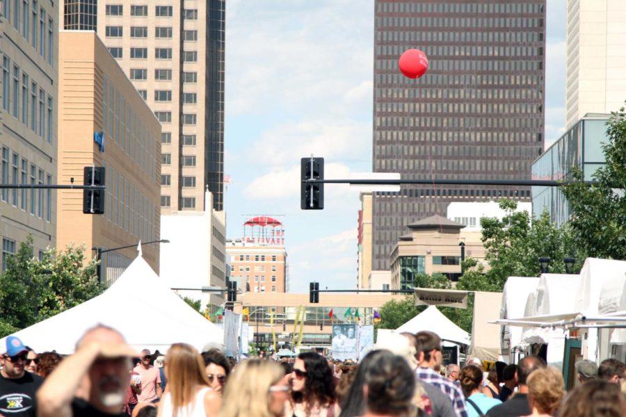 A red balloon sails above a large crowd of visitors at the Des Moines Arts Festival on June 24 in downtown Des Moines. The three day festival brings over 200,000 visitors every year.