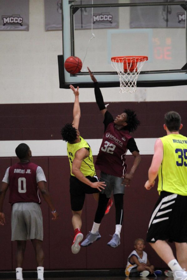 Lindell Wigginton and Malachi Canada jump for the ball during Thursday night's Capitol City League game in Ankeny.