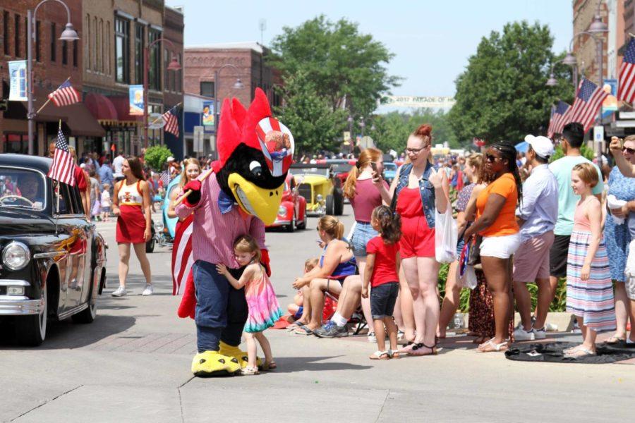 A girl hugs Cy during the Independence Day Parade on Main Street on July 4.