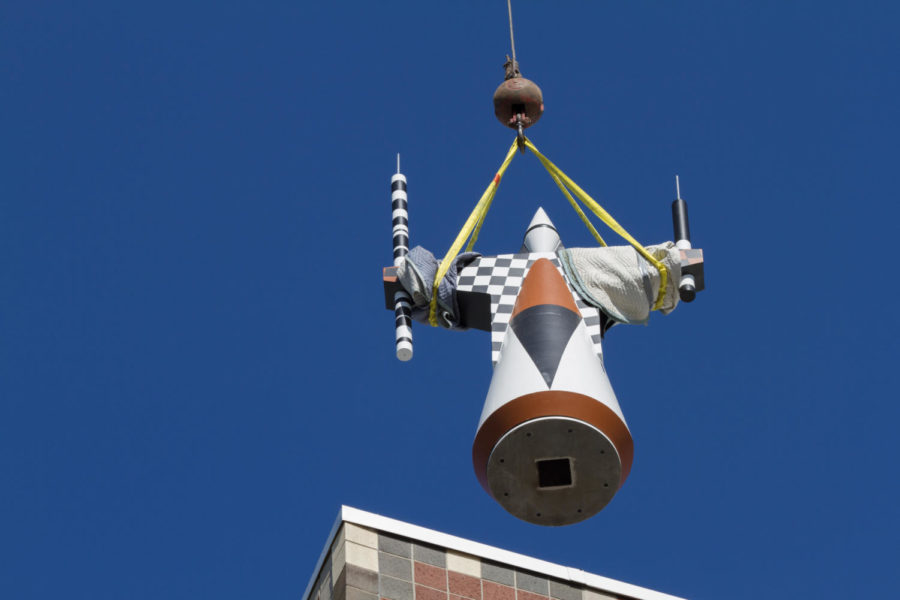 One of the new 400 pound metal G-Nomes is lifted to the top of the Molecular Biology building, during the early morning of July 24. After being on the Molecular Biology building since 1992, the old terracotta G-Nomes were crumbling, and needed to be replaced. 